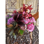 Bouquet of pink roses, dark calla lilies, and red orchids
