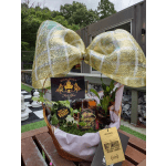 Gift basket with whiskey bottles, cards, and a large gold bow