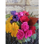 Bouquet of pink roses, purple blooms, and yellow daisies