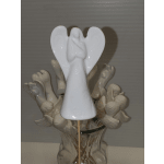 White ceramic angel figurine in a vase with decorative stems