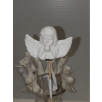 White angel figurine on a stick above a cluster of small angel ornaments