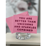 Pink card in a glass holder with a unicorn-themed message