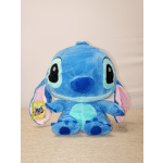 Blue Stitch plush toy with pink ears sitting on a table