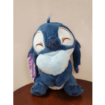 Blue plush toy with a smiling face and purple ear accents