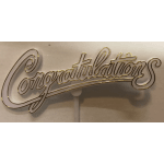 Gold "Congratulations" cake topper on a white backing