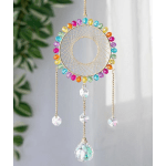 Colorful beaded dreamcatcher hanging indoors