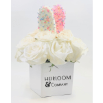 White roses in a white box with two sprinkle-covered popsicles