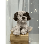 Plush dog toy sitting on a wooden box