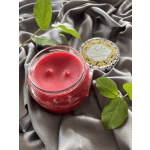 Red candle in a glass jar with a decorative lid