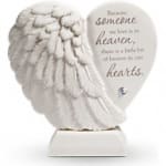 White angel wing memorial plaque with a quote on a base
