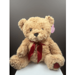 Plush teddy bear with a red ribbon bow