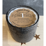 Black textured candle in a glass container with a labeled top