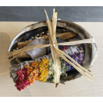 Bundle of colorful dried flowers tied with straw in a shell bowl