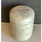 White honey suckle scented candle in a round container