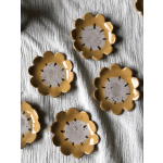Yellow flower-shaped ceramic dishes on a textured white cloth