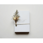 White gift box tied with twine and a small dried flower bundle