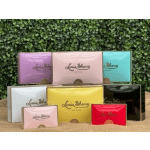 Assorted colorful rectangular gift tins arranged in tiers against a green backdrop