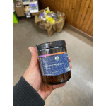 Hand holding a jar of Summer Solstice tea blend