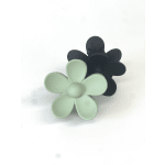 Two flower-shaped hair clips, one mint green and one black