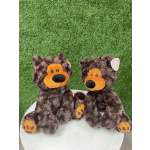 Two plush teddy bears sitting on a white surface