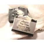 Black and white marbled tea tree charcoal soap bars on a white towel