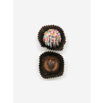 Two decorated chocolate truffles in brown paper cups on a white background