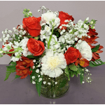 Red roses and white carnations in a glass vase with baby's breath
