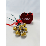 Heart-shaped box with Ferrero Rocher chocolates and a red ribbon