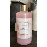 Pink bubble bath bottle with a gold cap and floral label