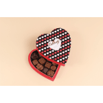 Heart-shaped box of assorted chocolates with a patterned lid of red and white hearts.