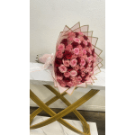 Large bouquet of pink and red roses wrapped in blush paper