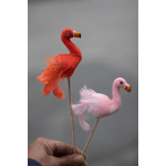 Two small pink and orange flamingo decorations on sticks