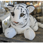 White plush tiger with black stripes sitting on a wooden surface