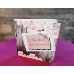 Wedding advice book with pink rose cover on a table