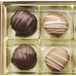 Box of assorted chocolate truffles in a gold tray