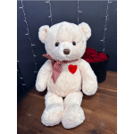 White teddy bear with a red checkered scarf beside a box of red roses