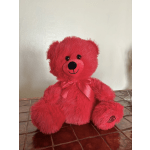 Bright pink plush teddy bear with a satin bow