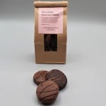 Bag of chocolate covered Oreos with three cookies in front