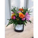 Mixed bouquet in a black jar vase with orange and purple flowers