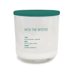 White candle in a glass jar with a teal lid and label