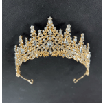 Gold jeweled tiara with clear stones on a black background