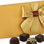 Gift box with a gold ribbon and assorted chocolates
