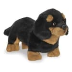 Plush black and tan dog toy on a white background