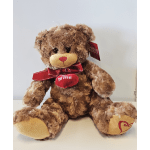 Brown teddy bear with a red ribbon and heart pendant