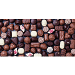 Assorted chocolates arranged in rows on a dark surface.