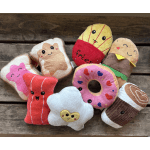 Assorted plush food-shaped toys on a wooden surface