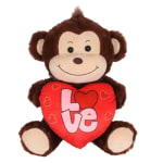 Brown plush monkey holding a red heart with the word Love