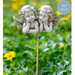 Two cherub garden stakes in a flower bed