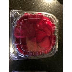 Clear plastic clamshell container holding red rose petals