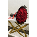 Large bouquet of red roses wrapped in black paper with a red ribbon